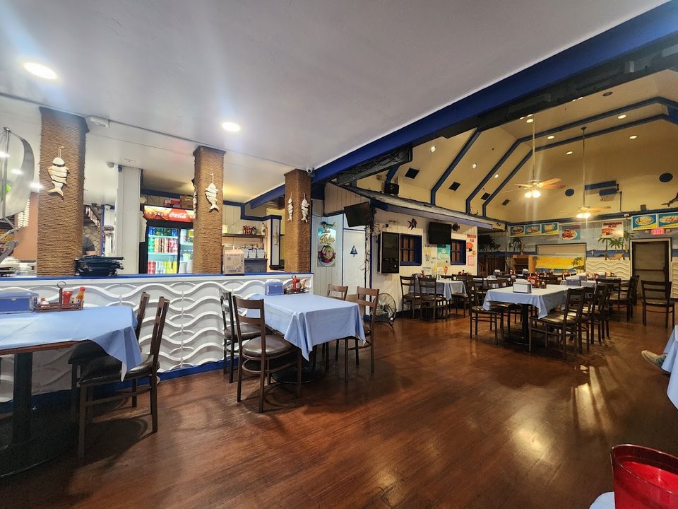Casual restaurant seating beside a bar.